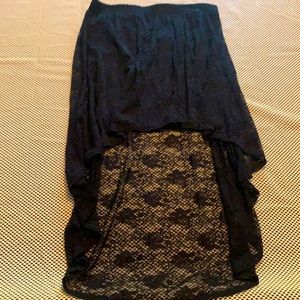 Short black skirt with a lace covering. One piece